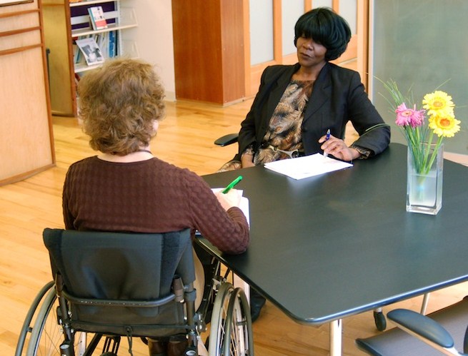 Two people talking at a table.