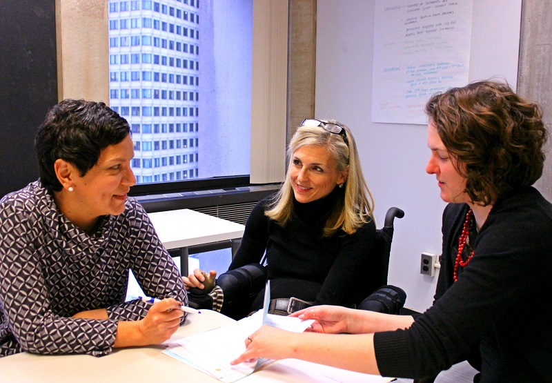 ADA coordinator and two staff members meeting.