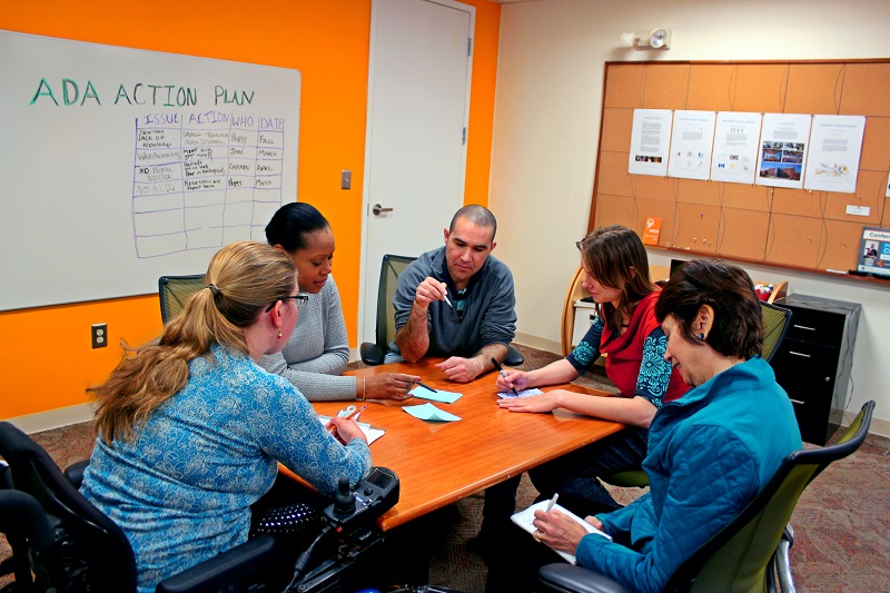 Five people working on action plan.