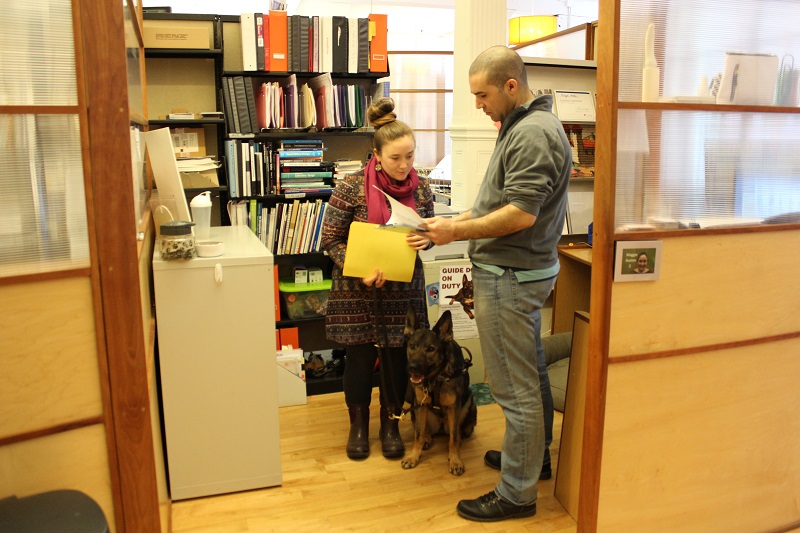 Employee who is blind and colleague discuss work document